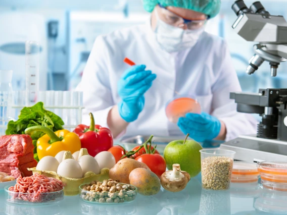 main in laboratory with fruits and vegetables holding petri dish