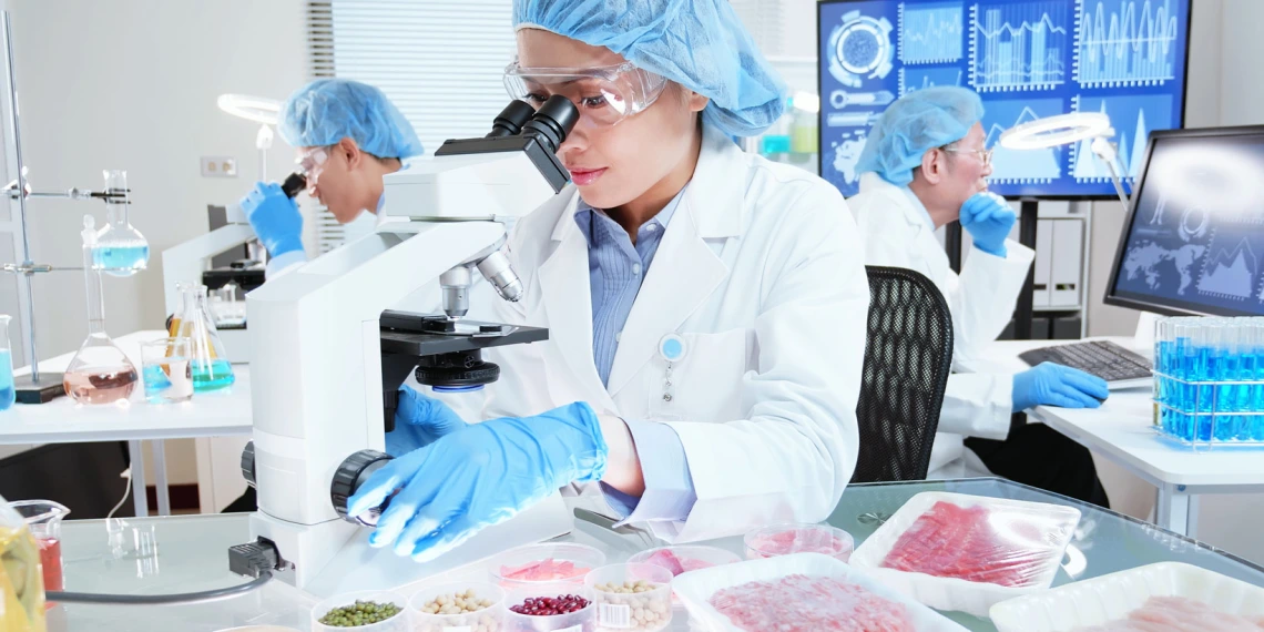 woman looking through microscope