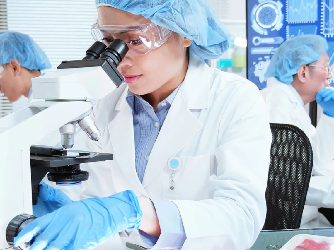 Woman looking in microscope