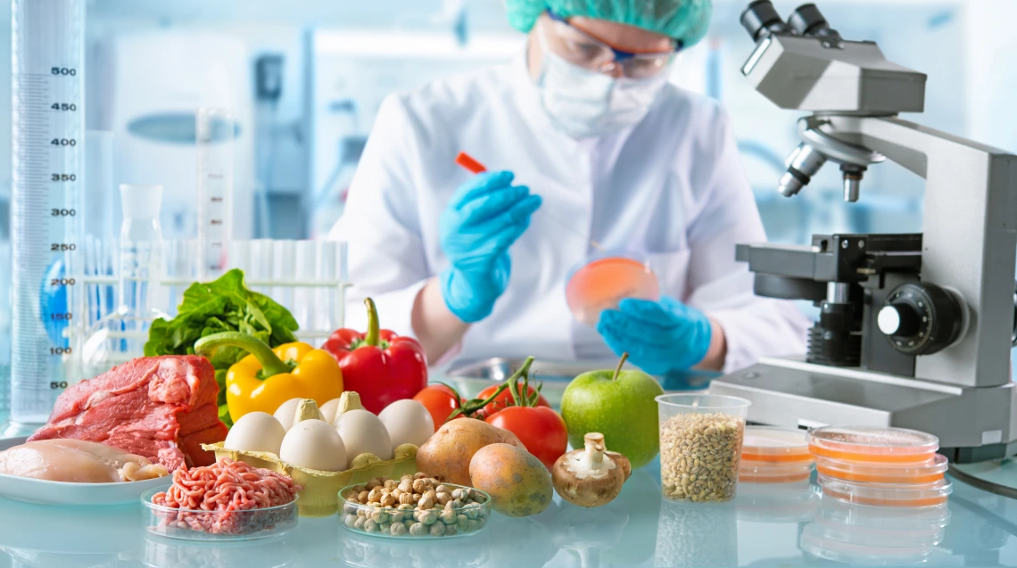 main in laboratory with fruits and vegetables holding petri dish