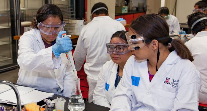 two female students with female instructor in lab